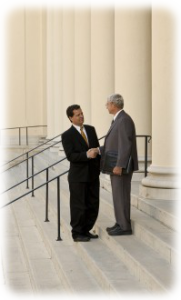 Two attorneys shaking hands on court steps